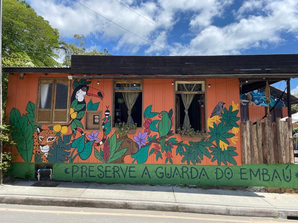a building with a painting on the side of it at Hostel Antônio Pescador Guarda do Embau in Guarda do Embaú