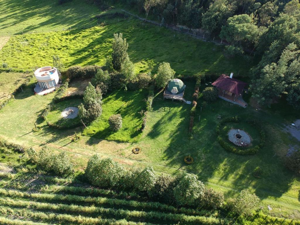 an aerial view of a yard with a house and trees at Glamping/BBQ Susa Cun in Susa