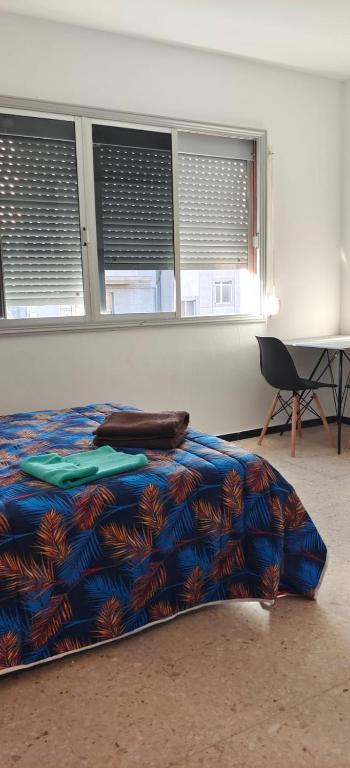 A bed or beds in a room at Lodge El Muelle Arinaga