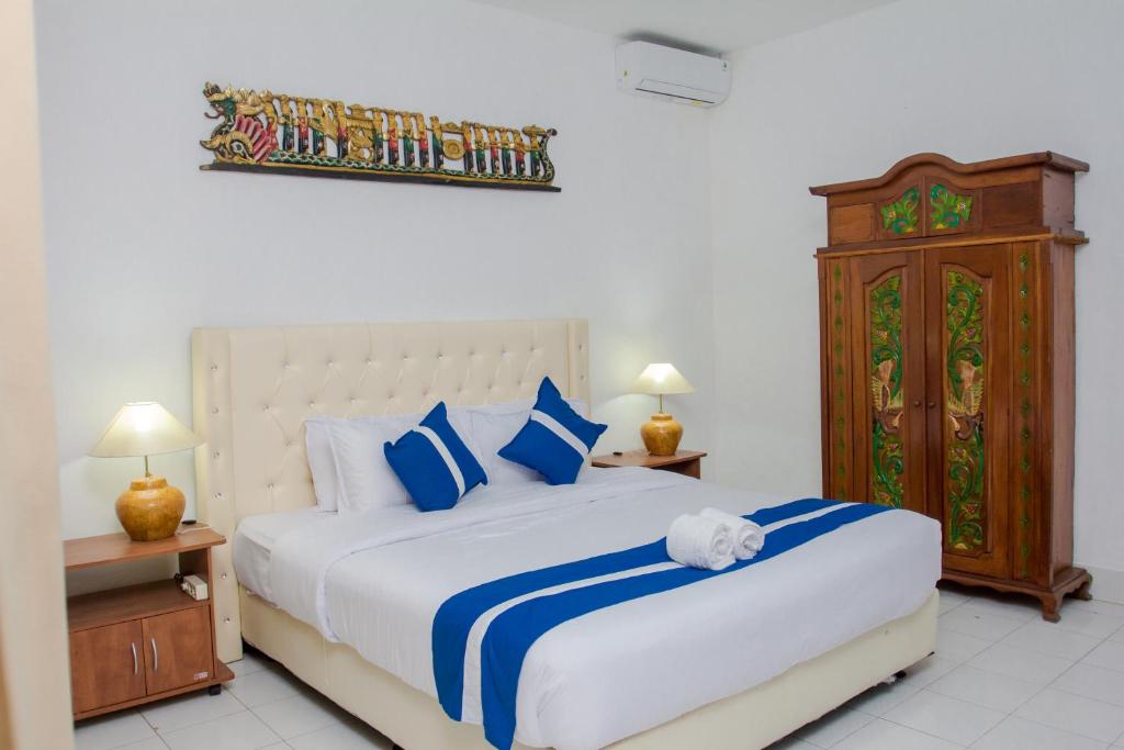 Postel nebo postele na pokoji v ubytování Matahari Inn Kuta Lombok