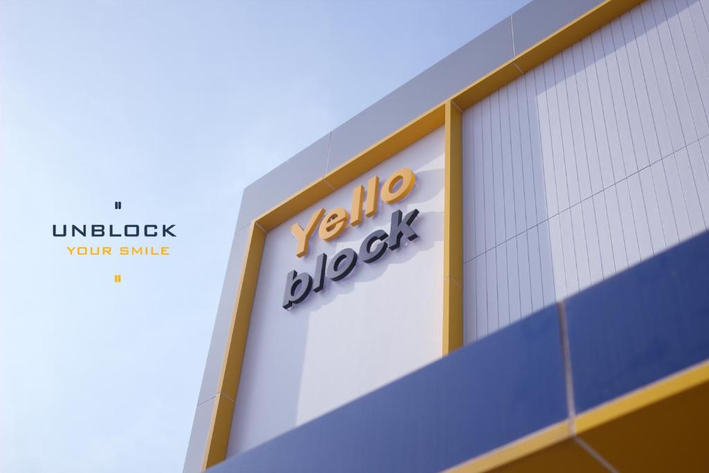 a sign on the side of a building at Yello Block Hotel 