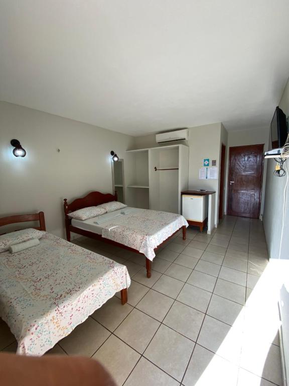 En eller flere senger på et rom på Pousada Do Vozinho