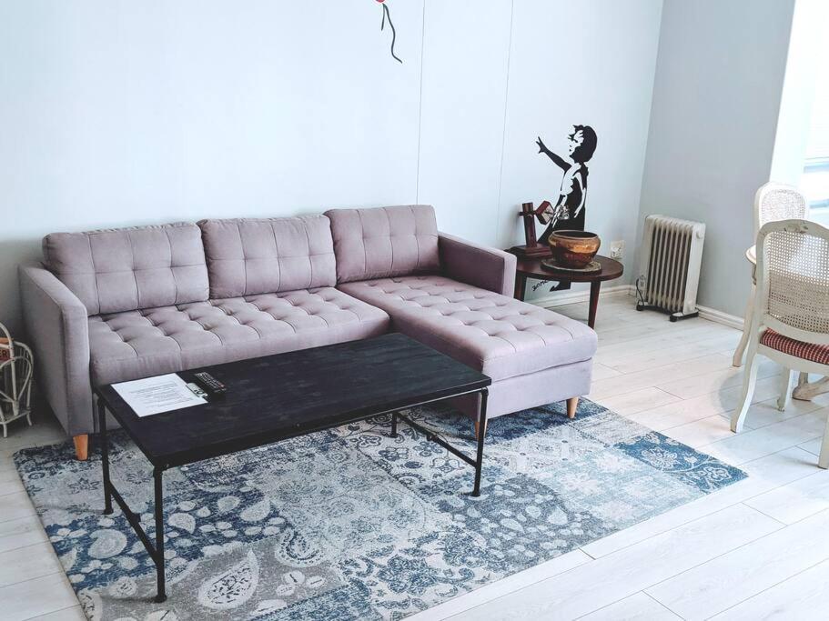 a living room with a couch and a coffee table at On The Beach at Surfers Corner in Cape Town