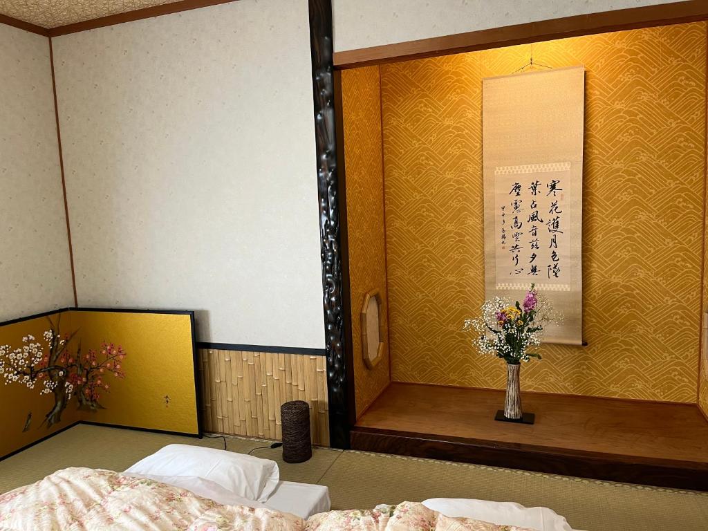 Postel nebo postele na pokoji v ubytování Kyoto Ryokan Gion Sano