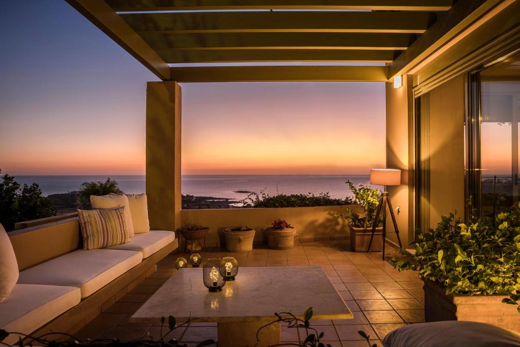 a patio with a view of the ocean at sunset at Villa nonà Maria in Minia