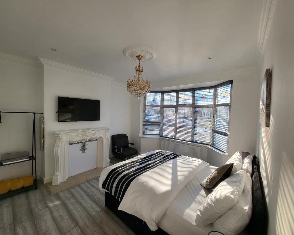 a bedroom with a bed and a fireplace and a television at Eastend Apartments in London