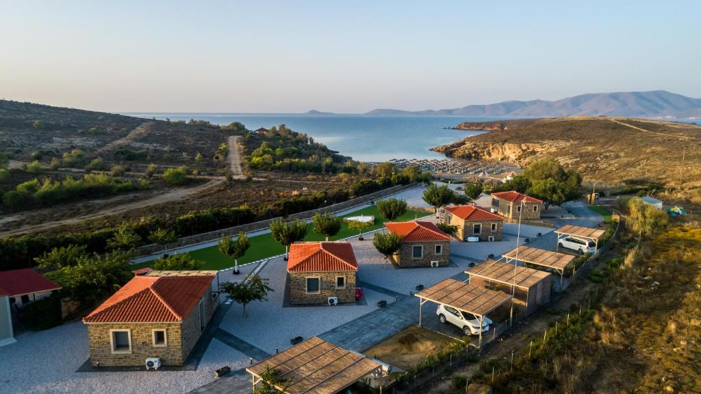 an aerial view of a village with houses and the water at Aphrodite Stone Apartments in Moúdhros