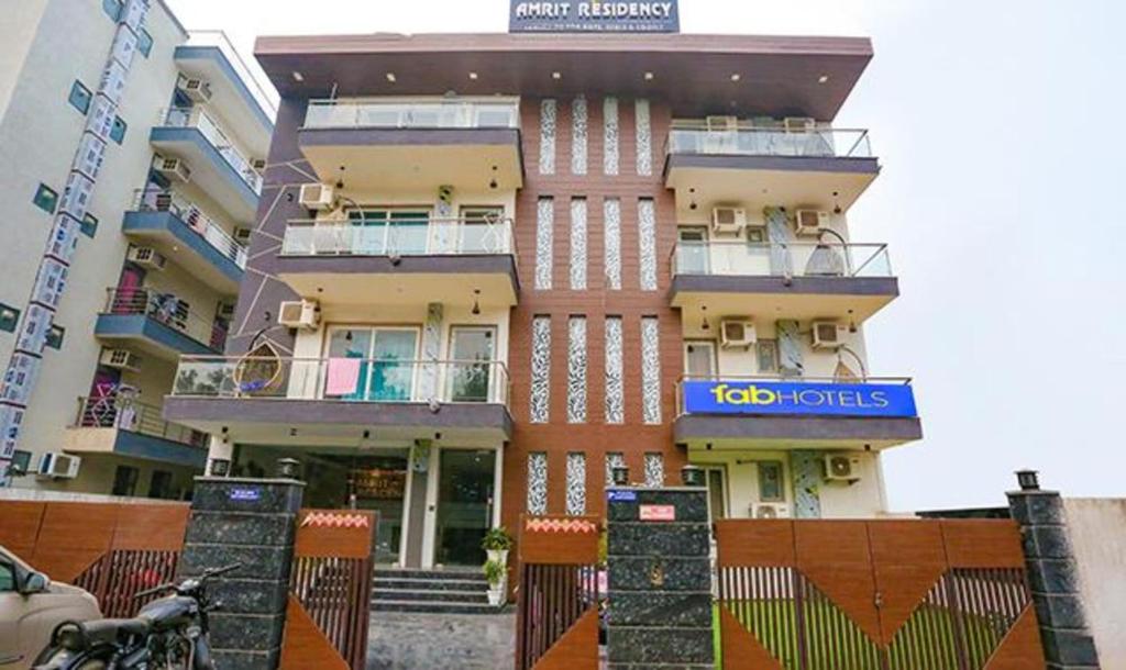 a building with a sign on the side of it at FabHotel Amrit Grand in Gurgaon