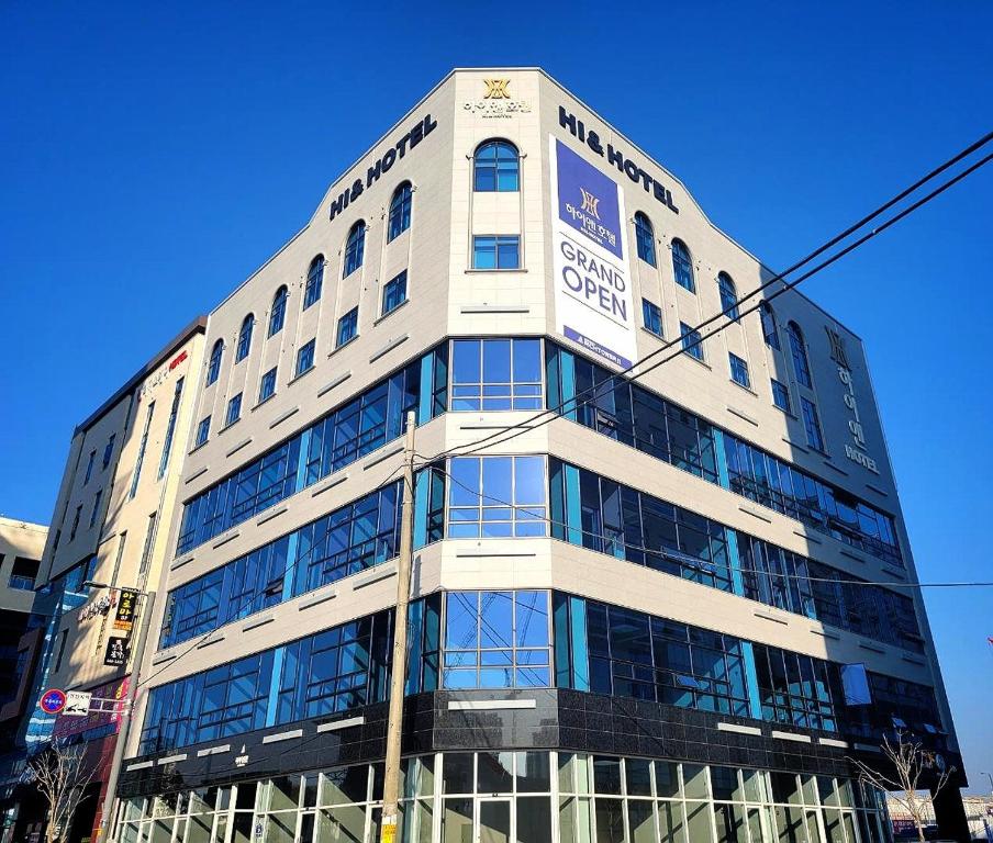 a building with a sign on the side of it at Hi& Hotel in Pyeongtaek