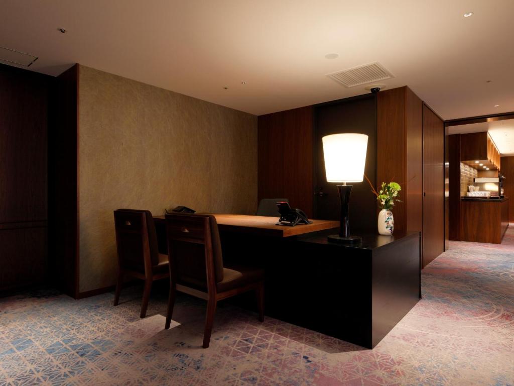 an office with a desk with chairs and a lamp at THE HOTEL SANRAKU KANAZAWA 21th December 2022 OPEN in Kanazawa