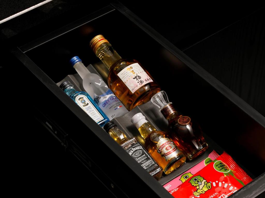 a drawer with several bottles of alcohol in it at THE HOTEL SANRAKU KANAZAWA 21th December 2022 OPEN in Kanazawa