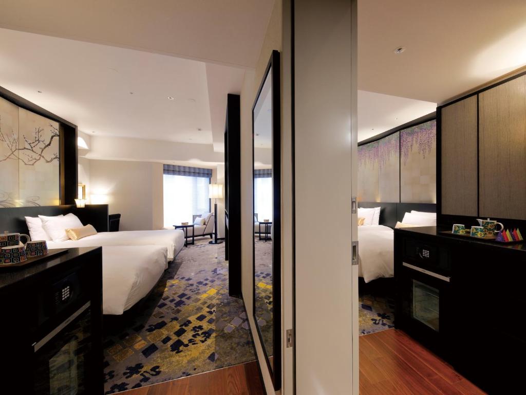 a hotel room with two beds and a bathroom at THE HOTEL SANRAKU KANAZAWA 21th December 2022 OPEN in Kanazawa