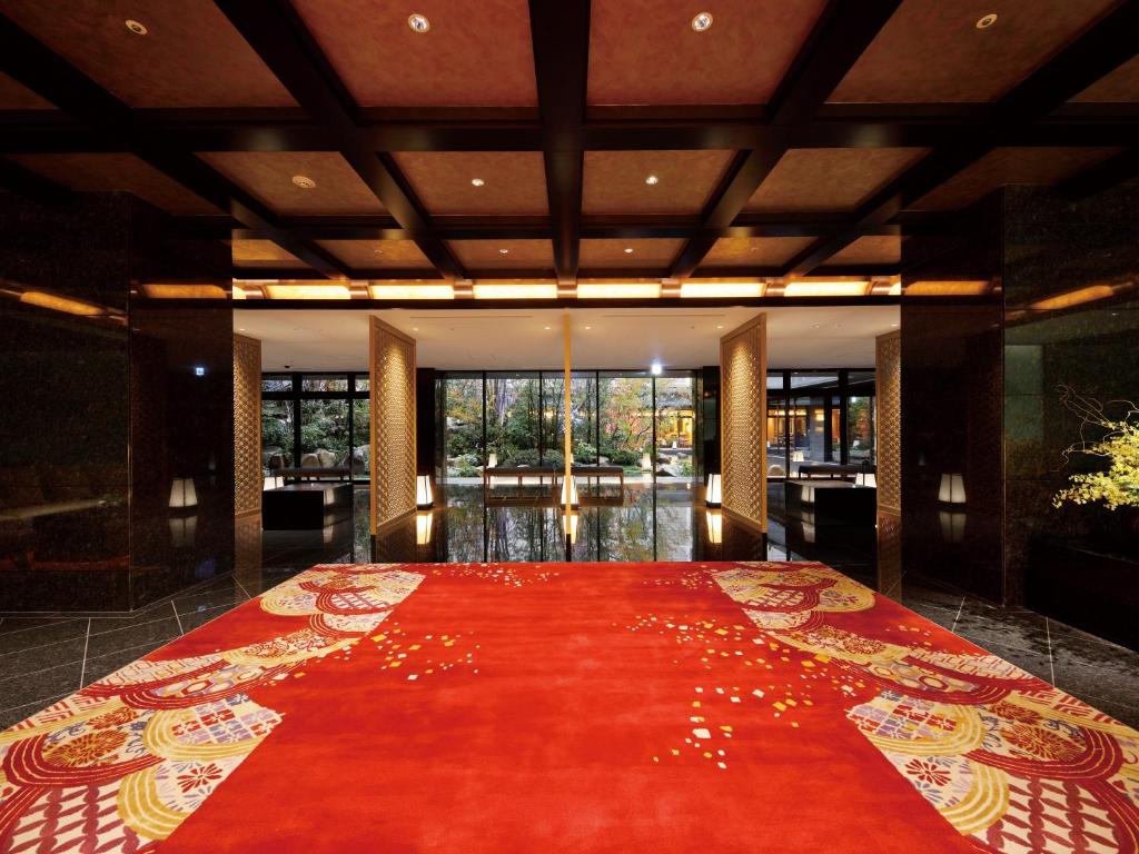 a large red carpet in a room with windows at THE HOTEL SANRAKU KANAZAWA 21th December 2022 OPEN in Kanazawa