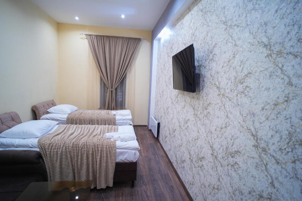 Postel nebo postele na pokoji v ubytování VN Hotel Vanadzor