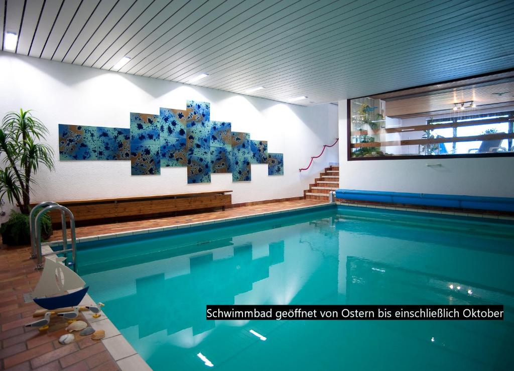 a swimming pool with a painting on the wall at Mosel-Appartements Nehren in Zell an der Mosel
