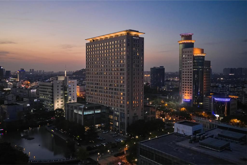 a city skyline at night with a tall building at Paradox Kunshan in Kunshan