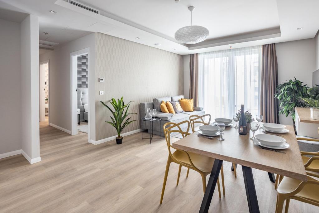 a dining room and living room with a table and chairs at K46 Residence in Budapest