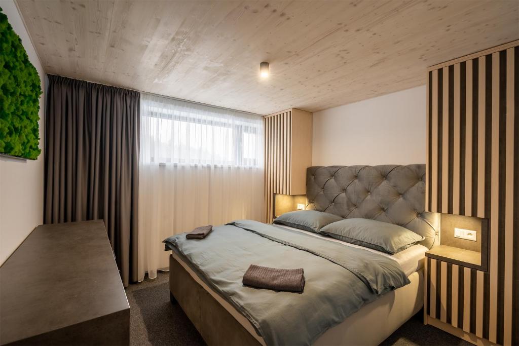una camera con un grande letto e una finestra di Chalet Malino - Apartments a Ružomberok