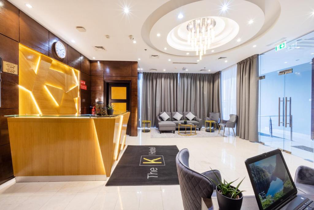 a lobby with a table with a laptop on it at THE K HOTEL in Dubai