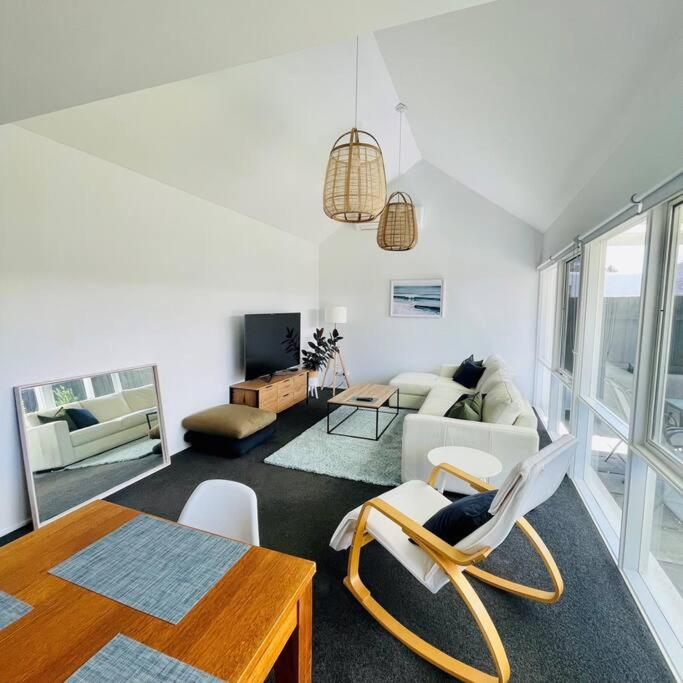 a living room with a couch and a table at A Wave From It All in Torquay