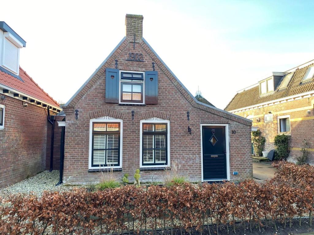 a brick house with a window on top of it at Holiday home by the Wadden Sea in Paesens