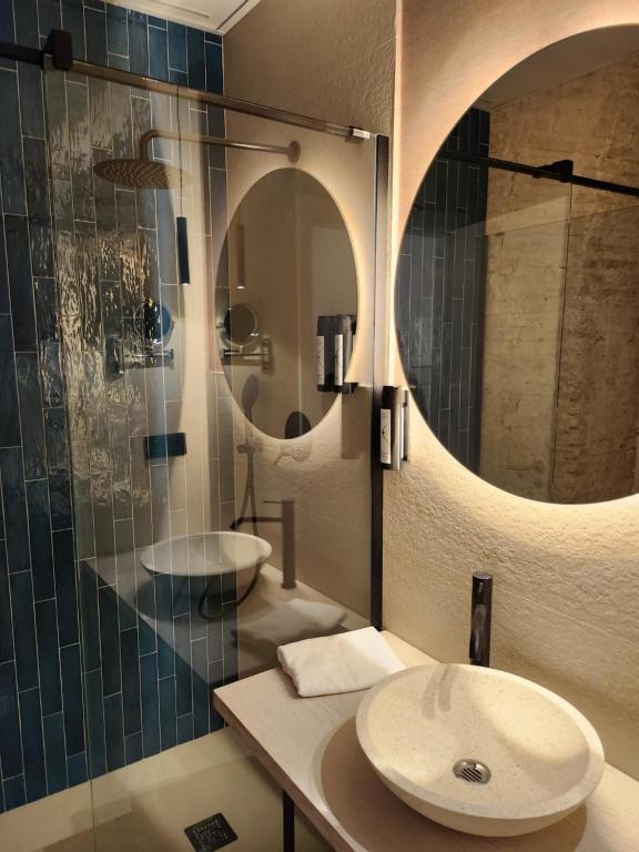 a bathroom with two sinks and a mirror at Soho Boutique Cádiz in Cádiz