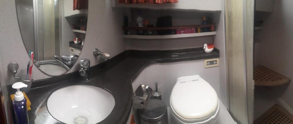 a small bathroom with a toilet and a sink at Blacky in Bodrum City