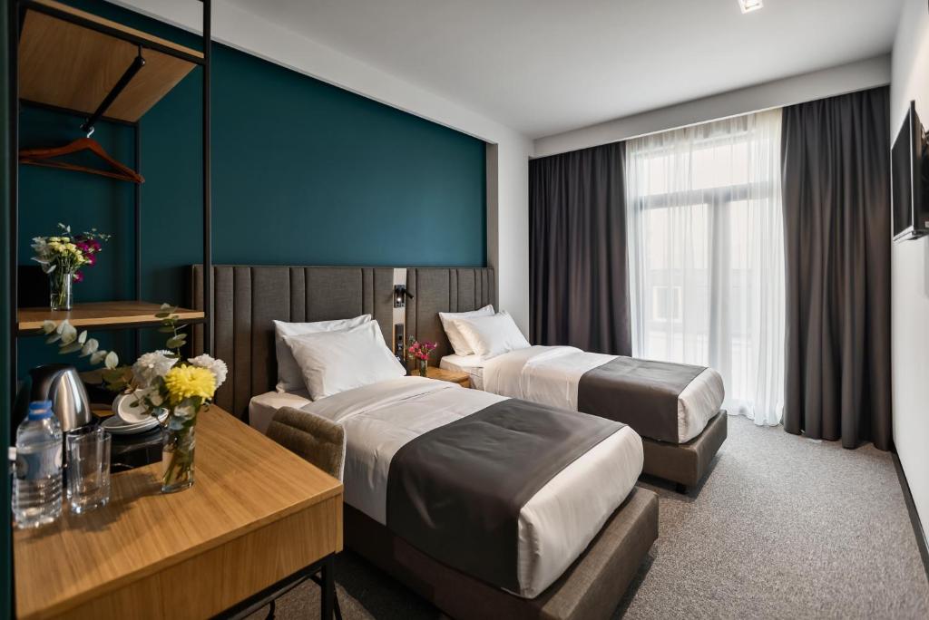 Postel nebo postele na pokoji v ubytování Graf Hotel