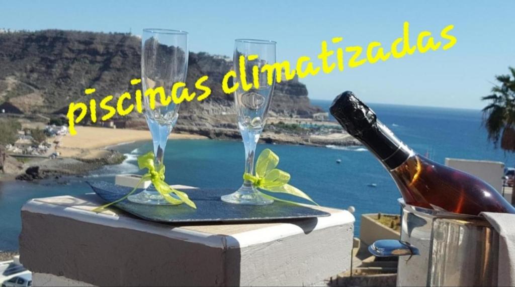 une table avec deux verres et une bouteille de vin dans l'établissement Apartamento Sur Monseñor, à Playa del Cura