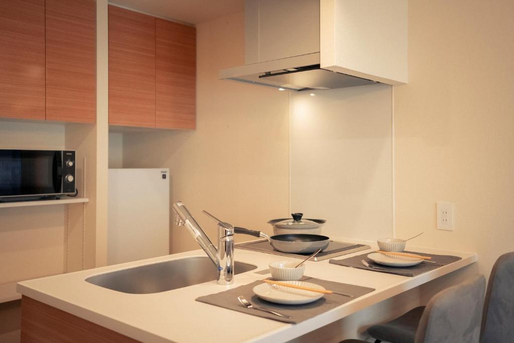 Kuchyň nebo kuchyňský kout v ubytování 谷町君HOTEL 心斎橋東32