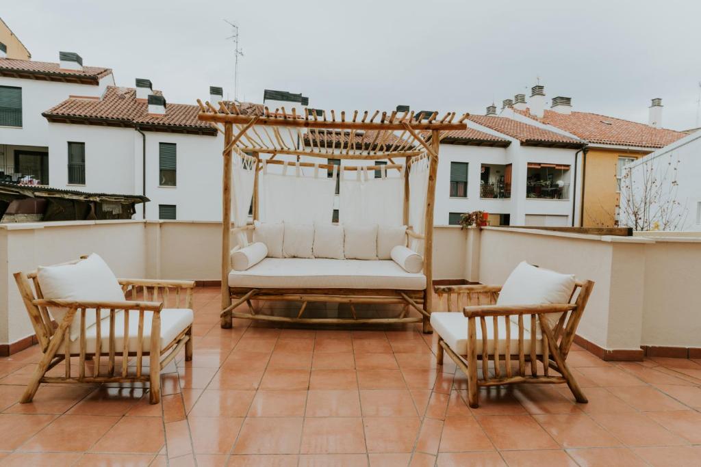 eine Veranda mit einer Schaukel und Stühlen auf dem Dach in der Unterkunft Natural Stay Apartamentos PassivHaus in Logroño