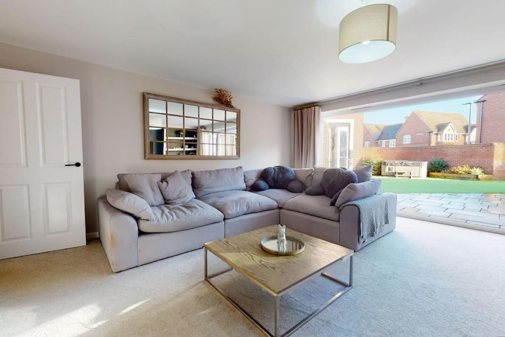 a living room with a couch and a table at Magnolia House in Leamington Spa