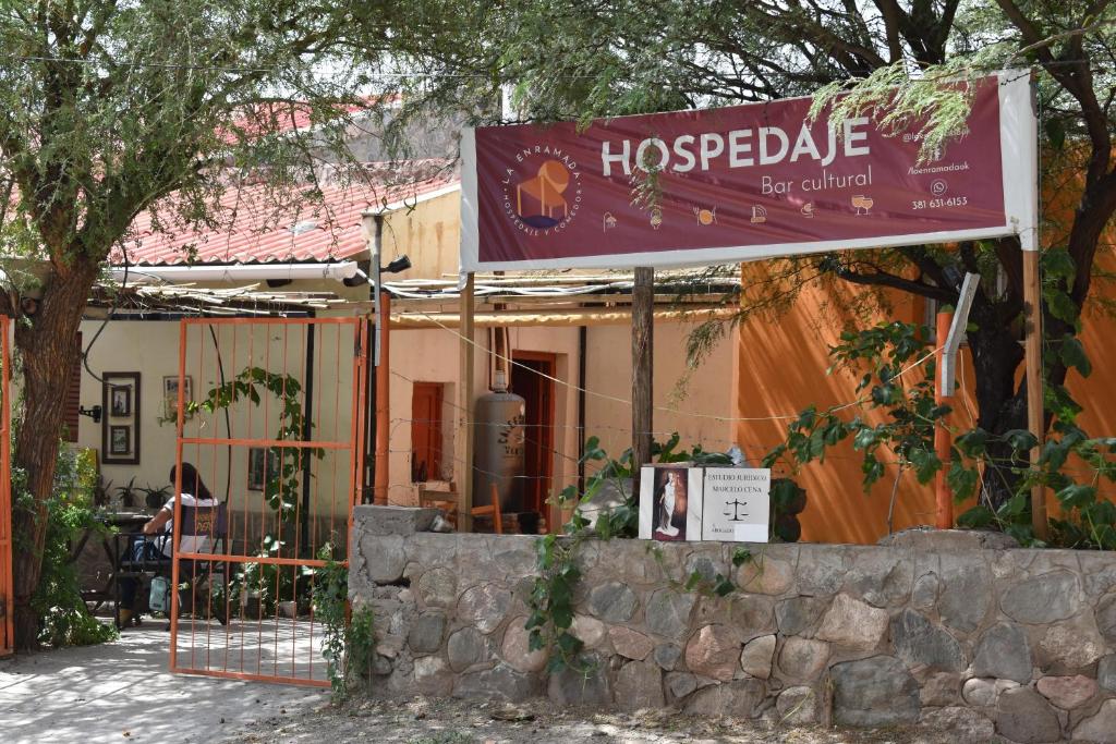a sign for a hospedale restaurant in front of a building at La Enramada in Amaicha del Valle