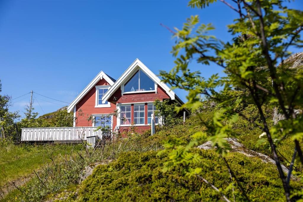 a red house on top of a hill at Sharming cabin in Sund in Sund