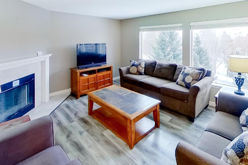a living room with two couches and a tv at Park Pointe Mutual in Chelan
