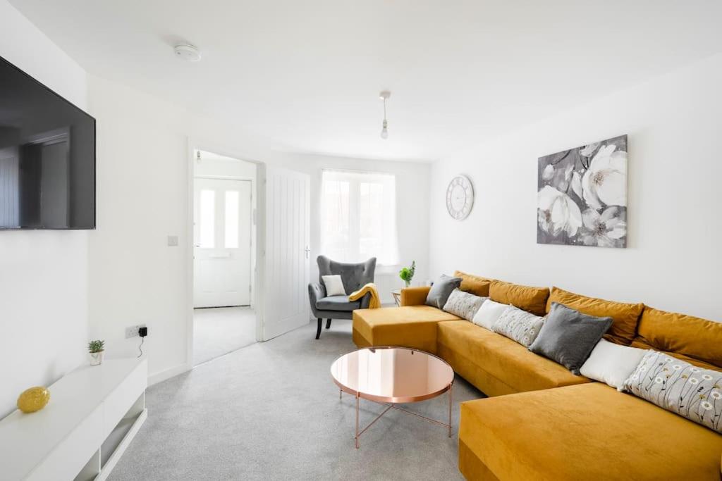 a living room with a couch and a table at Fortified Three Bedroom Home Bristol 