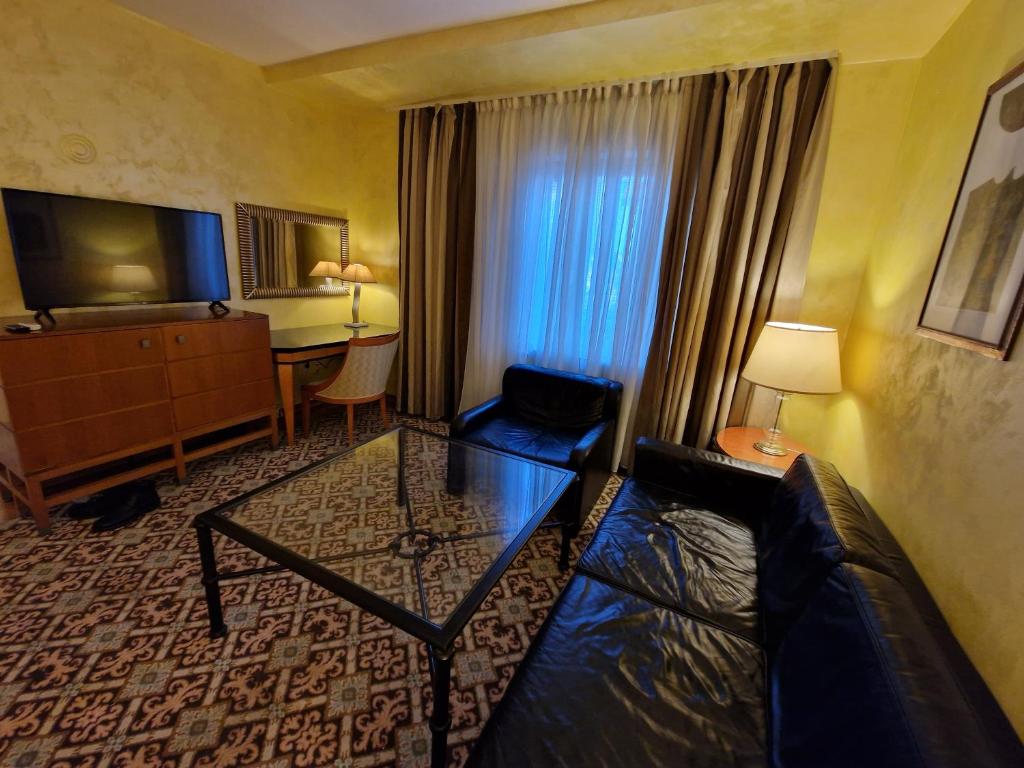 a hotel room with a couch and a table at Avalon Apartments in Belgrade