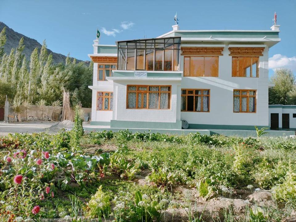 a house with a garden in front of it at Tsabgyat Homestay in Leh