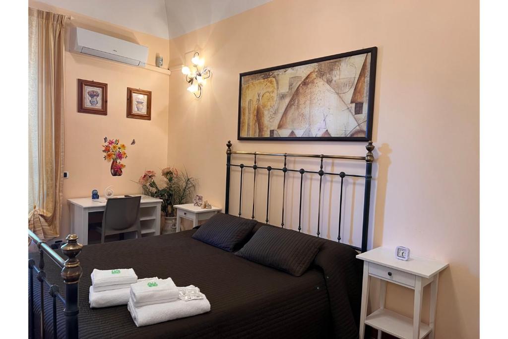 a bedroom with a bed and a table with chairs at Airport Rooms - Bari in Bari