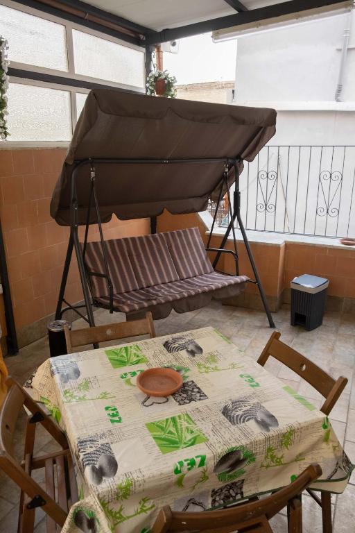a table and chairs with a piano on a balcony at Casa vacanza russo enzo in Naples