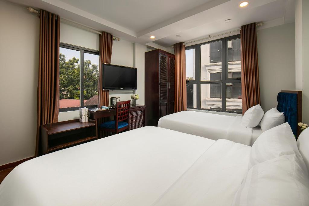 Cristina Center Hotel & Spa tesisinde bir odada yatak veya yataklar