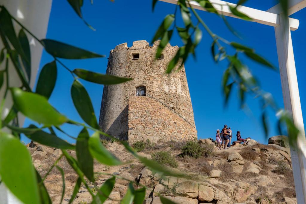 a castle on a hill with people standing on it at Il Mirto in Bari Sardo