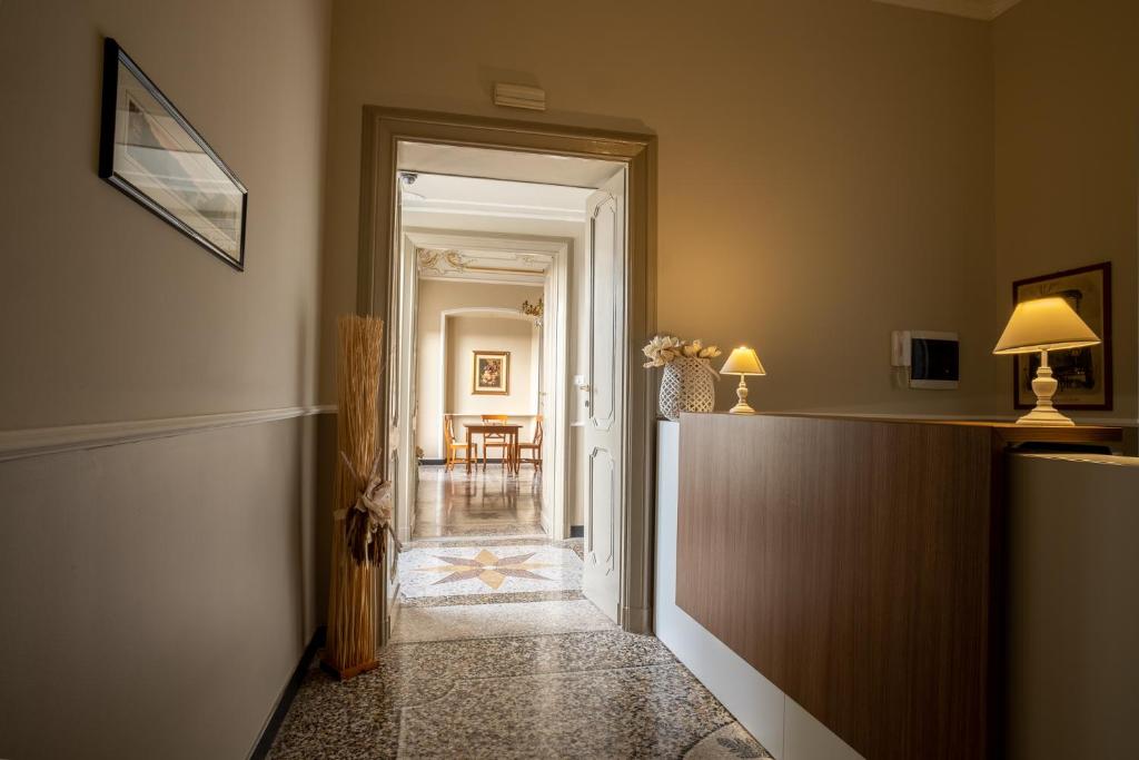 a hallway with a hallway leading to a dining room at CORVETTO rooms in Genova