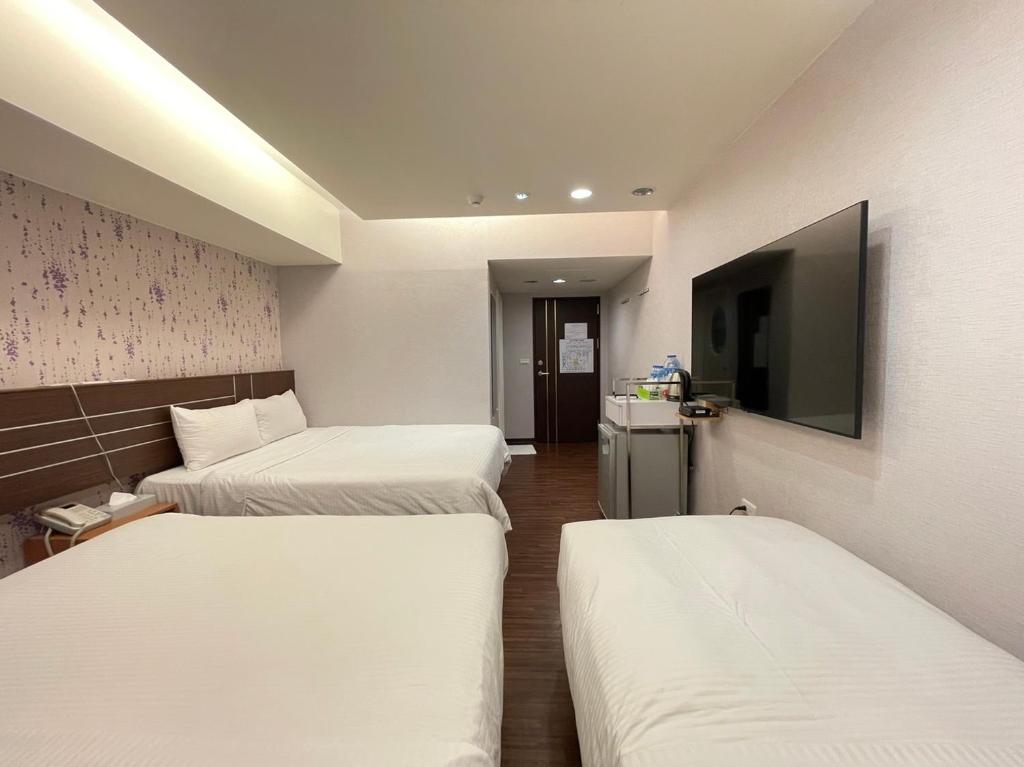 Postel nebo postele na pokoji v ubytování Jung Shin Hotel