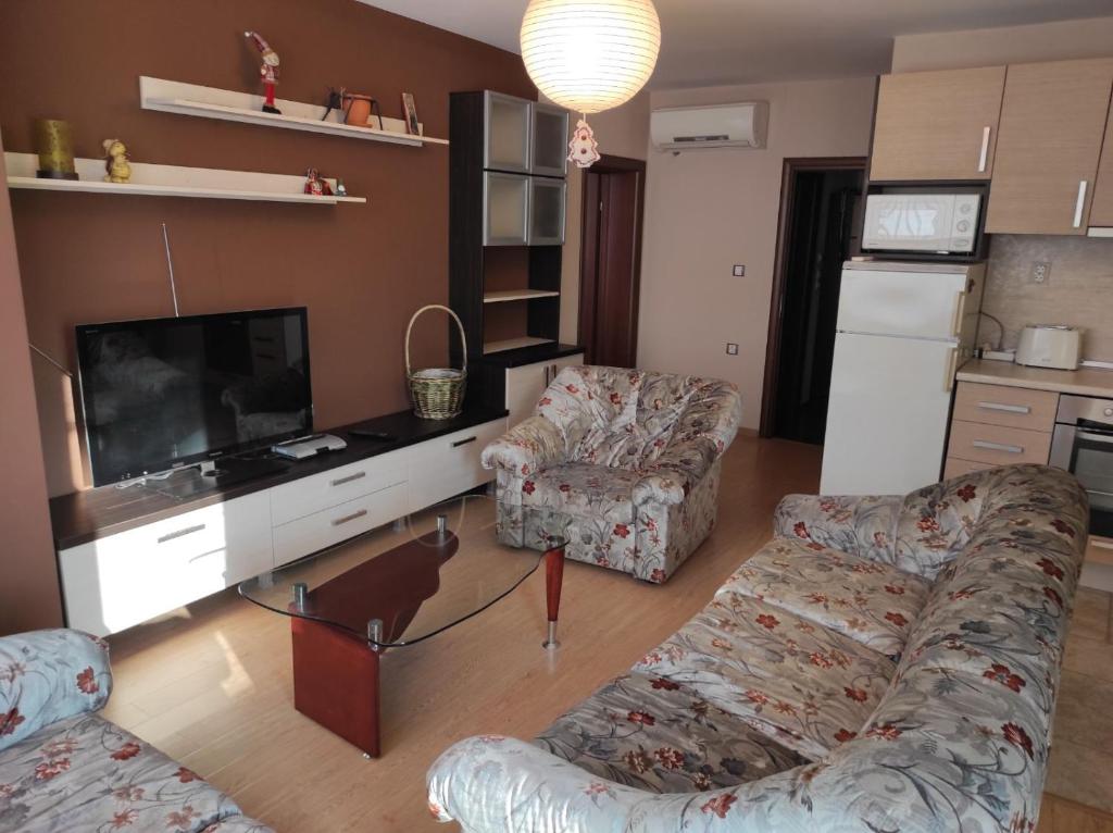 a living room with two couches and a flat screen tv at Слънчев апартамент с прекрасна гледка, паркинг. in Smolyan