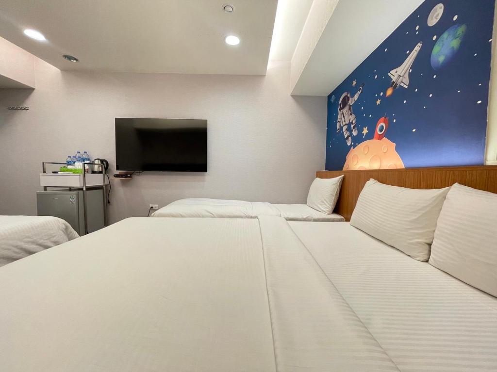Postel nebo postele na pokoji v ubytování Jung Shin Hotel
