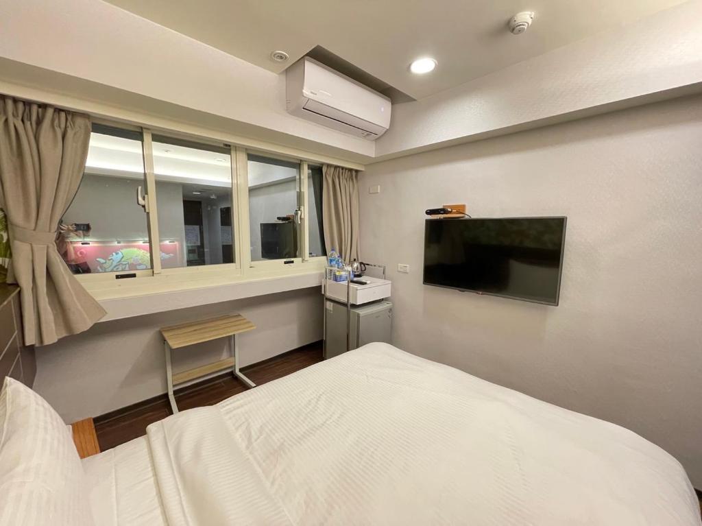 Postel nebo postele na pokoji v ubytování Jung Shin Hotel