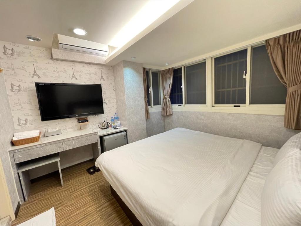 Postel nebo postele na pokoji v ubytování Jung Shin Hotel
