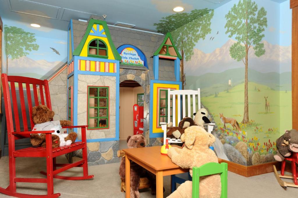 a group of teddy bears sitting in chairs in a play room at The Springs Condominiums by Keystone Resort in Keystone