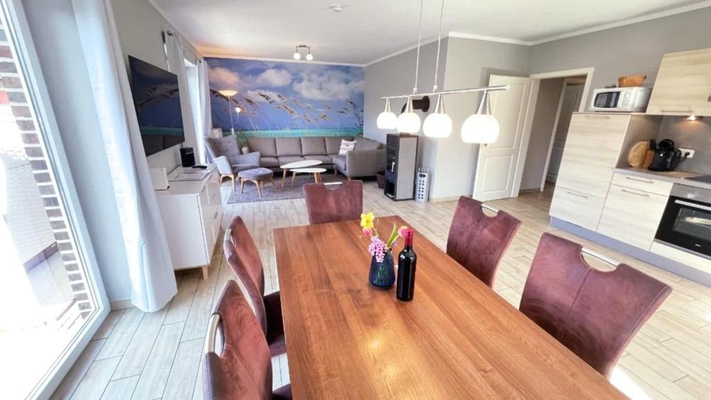 a dining room with a wooden table and chairs at "Bauernhof-Claussen", Haus Sonne in Sahrensdorf